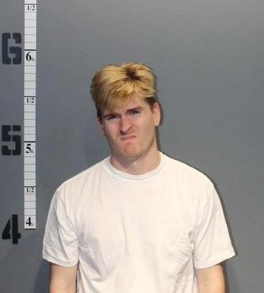 George Pickard of Virginia Beach mugshot. Pickard was arrested on federal gun charges in 2020. He's wearing a white t-shirt. He has blonde hair and he's snearing. George does not look happy to be arrested.