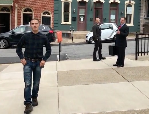 William Ring mugging for the cameras leaving court following assault on a teenage girl with lawyers in the background